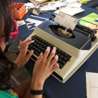 Typing up a postcard at the activities tent
